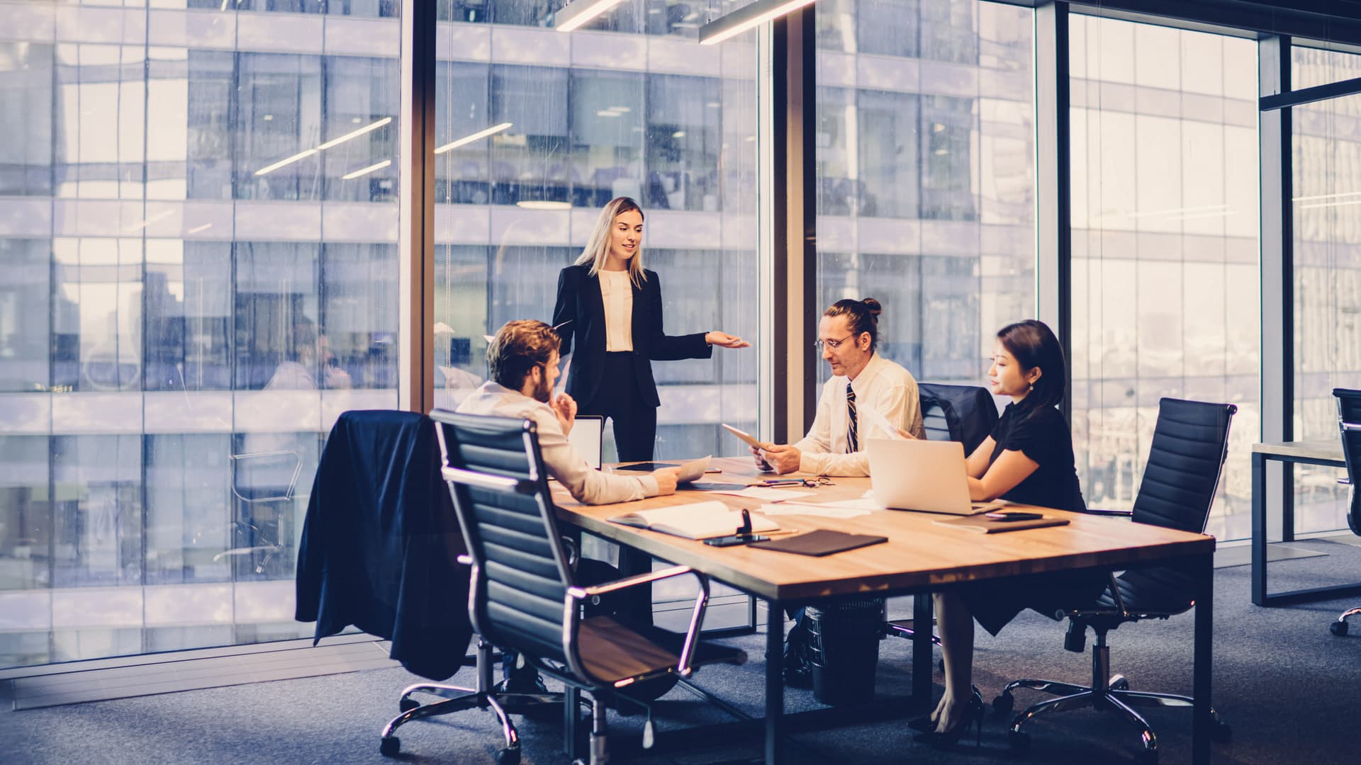 Professional financial experts collaborating during brainstorming meeting listening information from clever female director, businesswoman providing information to corporate workers of company